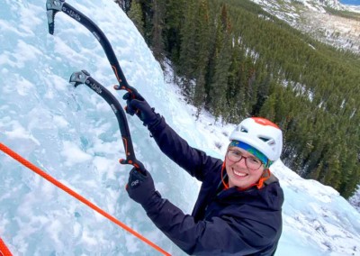 Woman learning to multi pitch ice climb in the David Thompson Corridor, Alberta