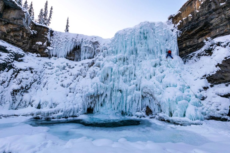 Ice climber climbing Upper Crescent Falls, In David THompson Country, Alberta