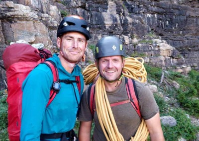 Tim Taylor, ACMG Guide, smiling with a client while alpine climbing in the Alberta Rocky Mountains