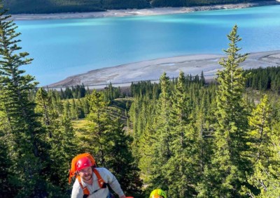 Man and two children multi pitch Rock climbing on the David Thompson Corridor, near Nordegg, Alberta