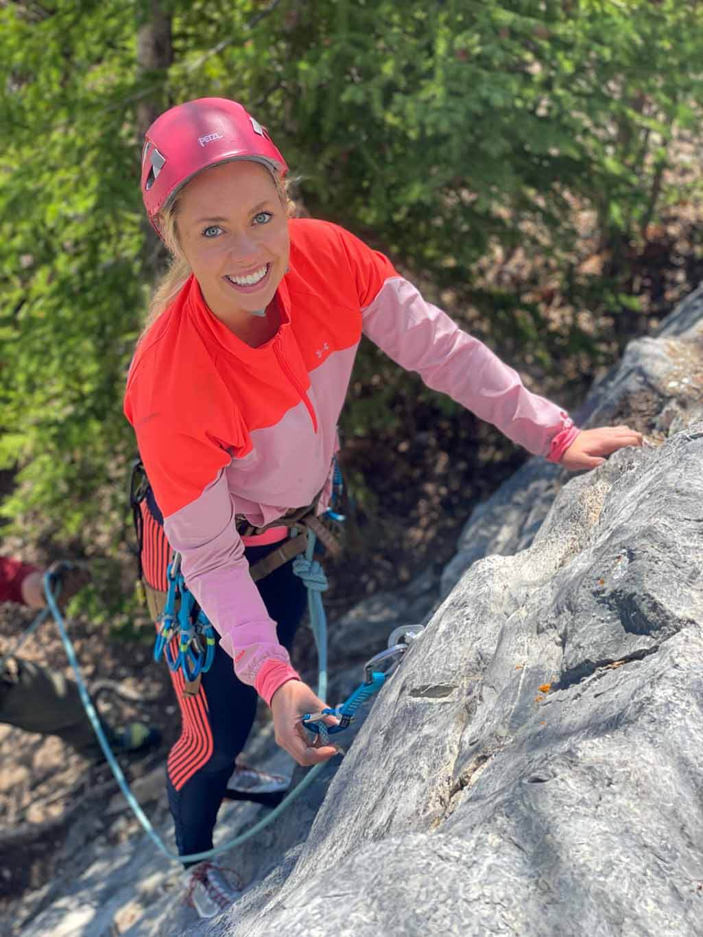 Woman learning to lead climb on rock on the David Thompson Corridor, near Nordegg, Alberta