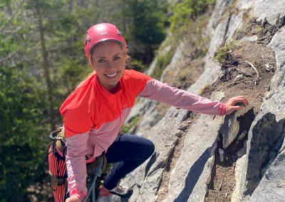 Woman learning to lead climb on rock on the David Thompson Corridor, near Nordegg, Alberta