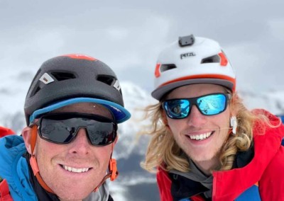 Tim Taylor with a smiling client while alpine climbing in the Alberta Rocky Mountains