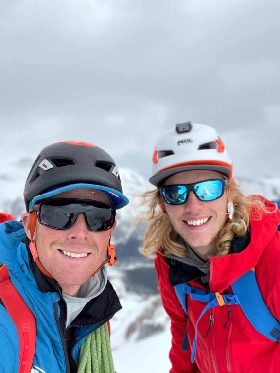 Tim Taylor with a smiling client while alpine climbing in the Alberta Rocky Mountains