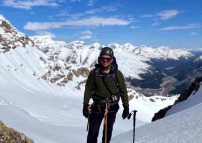 Smiling alpine climber alpine climbing in the Alberta Rocky Mountains
