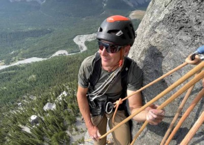 Tim Taylor at a belay station while climbing rock climbing on the David Thompson Corridor, near Nordegg, Alberta