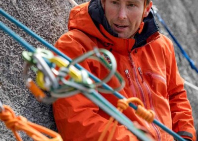 Tim Taylor, ACMG Guide teaching climbers to multi pitch climb on rock outside rock climbing on the David Thompson Corridor, near Nordegg, Alberta