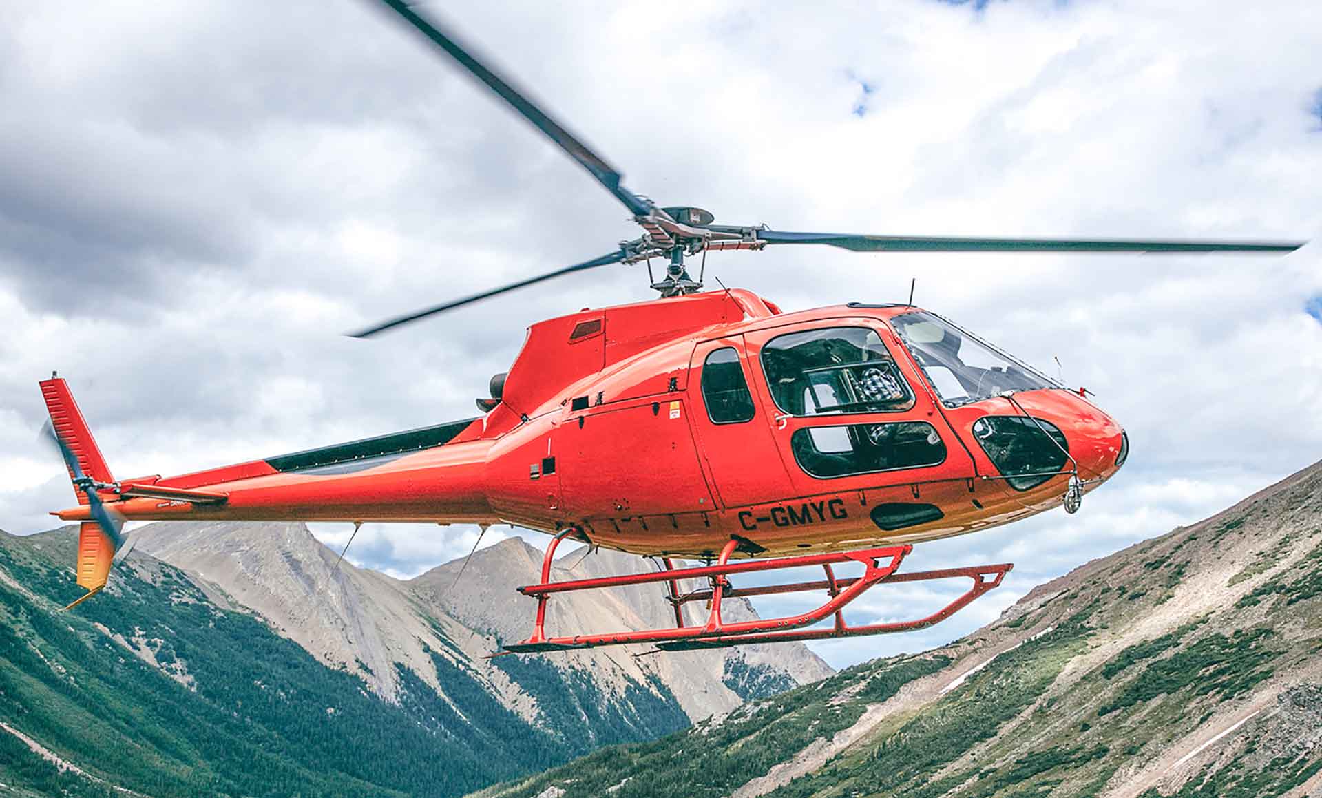 Rockies Heli Red Helicopter taking off from the David Thompson Highway