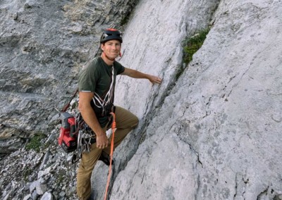Tim Taylor establishing a new route with a hammer drill in the Nordegg/Lake Abraham area of Alberta