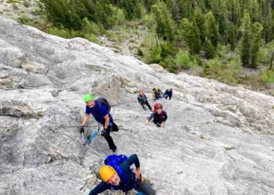Group of friends climbing the Fox Via Ferrata West of Nordegg, Alberta