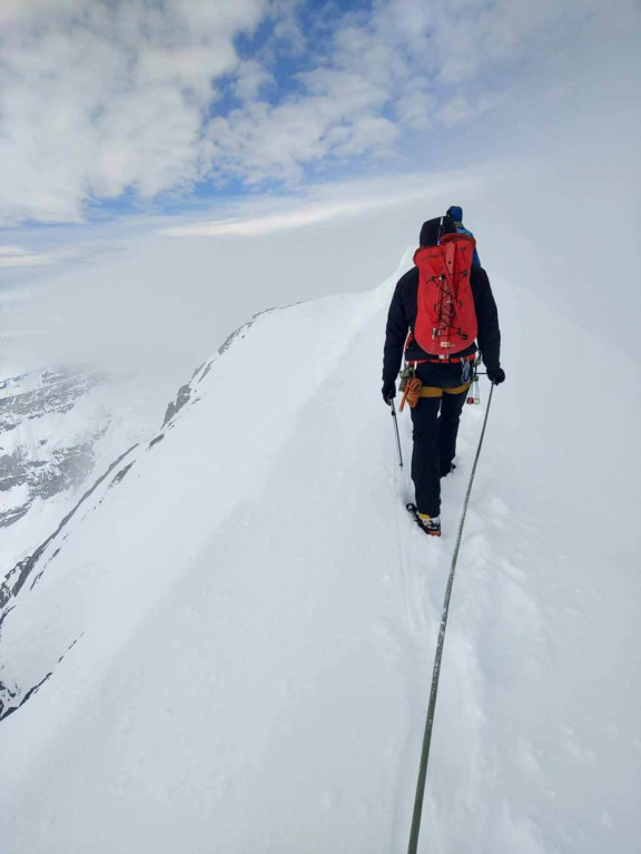 Tim Taylor guiding a client while alpine climbing in the Alberta Rocky Mountains