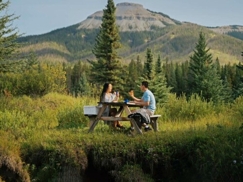 A couple having a picnic at the foot of Coliseum Mountain in Nordegg, alberta
