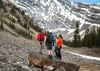 Indigenous guide leading a hike with a mountain in the background