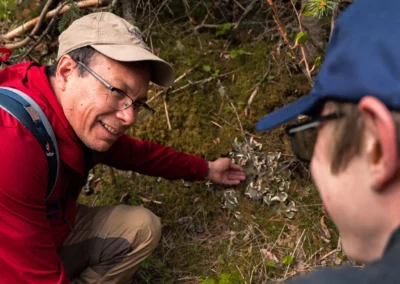 Indigenous guide leading a hike explaining plants