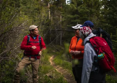 Indigenous guide leading a hike, explaining a historic story